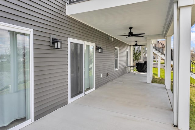 view of patio featuring stairs and ceiling fan