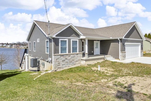 view of front facade with an attached garage, driveway, central AC unit, and stone siding