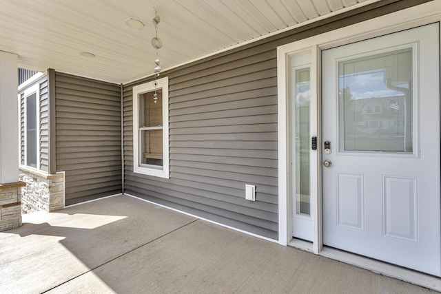 property entrance featuring stone siding