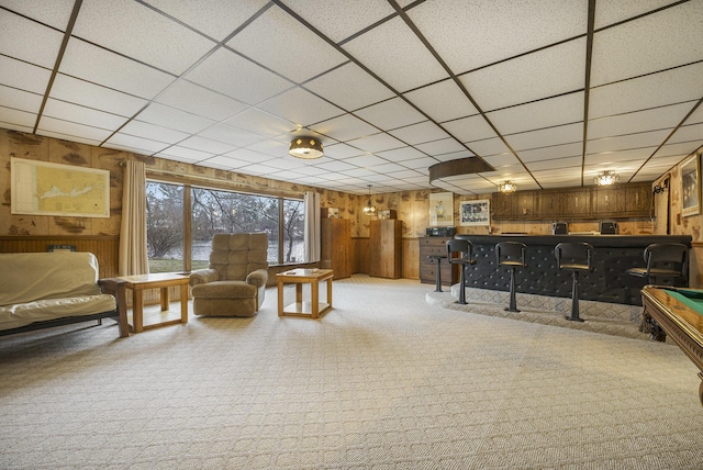 52473 Sheridan Rd, Paw Paw, MI 49079 - living room with wooden walls, wet bar, carpet floors, and a drop ceiling