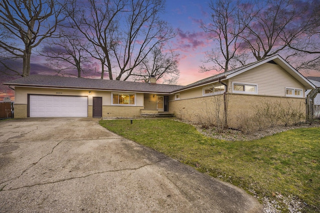 52473 Sheridan Rd, Paw Paw, MI 49079 - view of front facade with brick siding, a garage, concrete driveway, and a chimney
