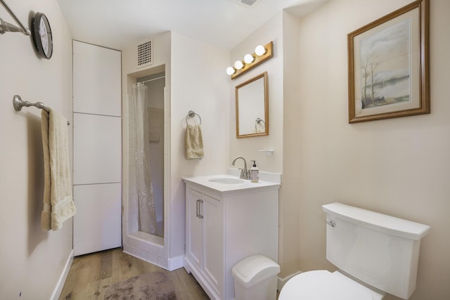 52473 Sheridan Rd, Paw Paw, MI 49079 - bathroom with toilet, wood finished floors, vanity, and curtained shower