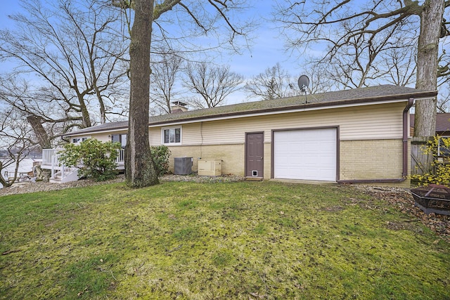 52473 Sheridan Rd, Paw Paw, MI 49079 - rear view of house featuring brick siding, a yard, a chimney, and central AC