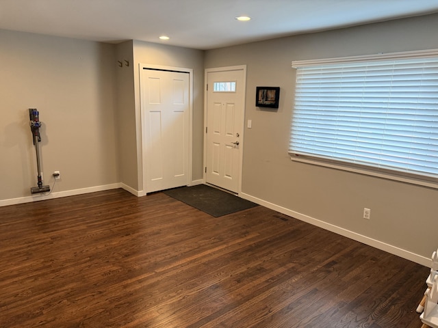 foyer featuring recessed lighting, baseboards, and dark wood-style flooring