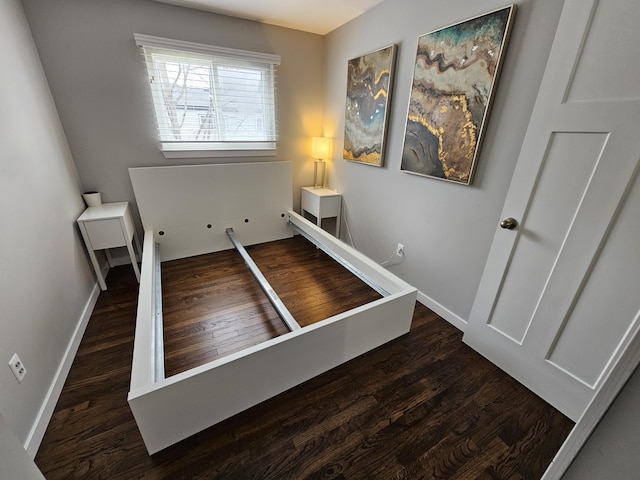 stairway featuring baseboards and wood finished floors