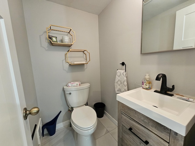 bathroom featuring toilet, baseboards, and vanity