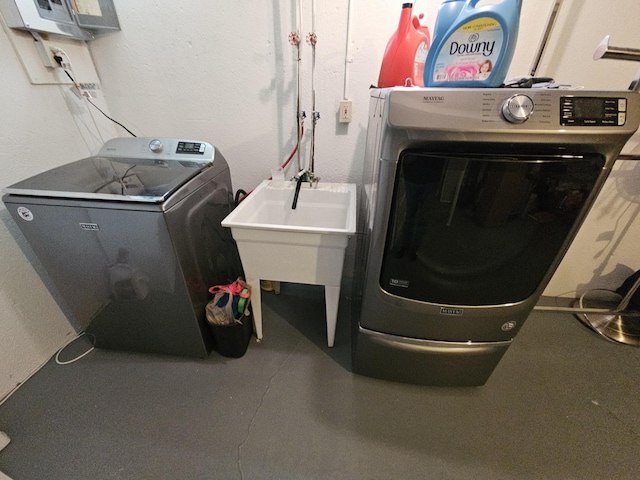 clothes washing area featuring washer and dryer and laundry area