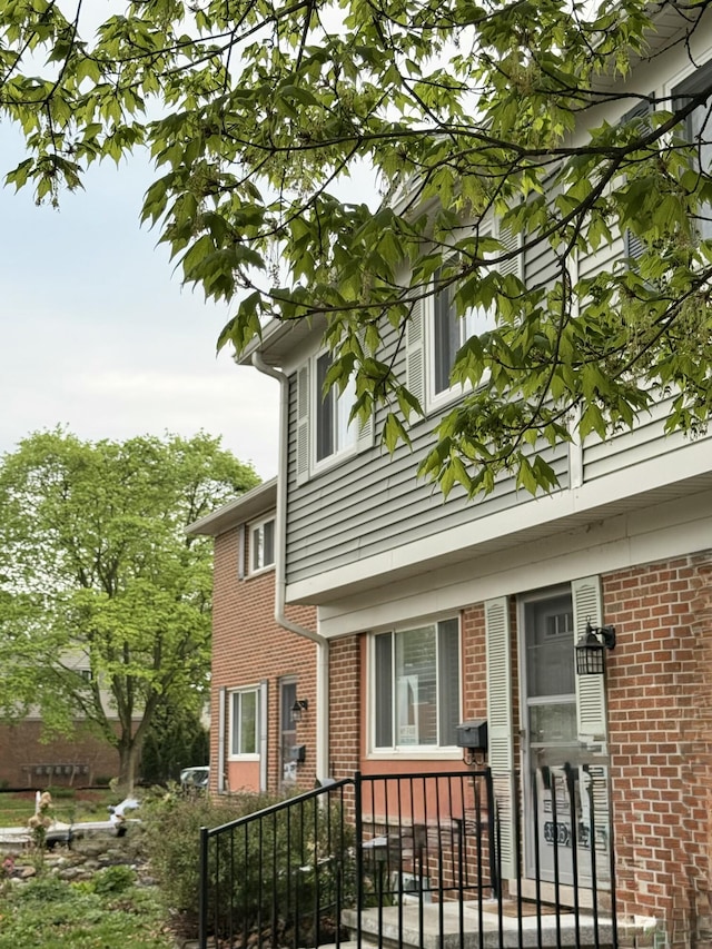 view of property exterior featuring brick siding