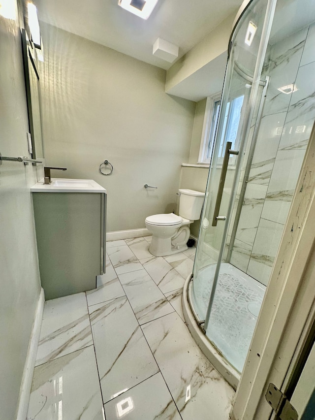 full bath featuring vanity, toilet, marble finish floor, a marble finish shower, and baseboards