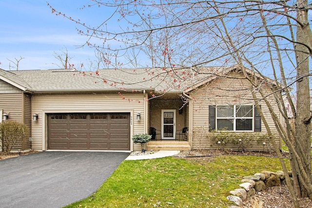 ranch-style house with a garage, a front yard, roof with shingles, and driveway