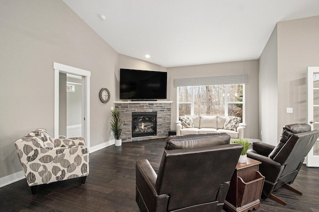 living area featuring baseboards, lofted ceiling, a fireplace, and dark wood finished floors