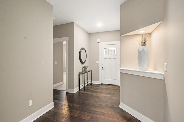 entrance foyer featuring baseboards and hardwood / wood-style flooring