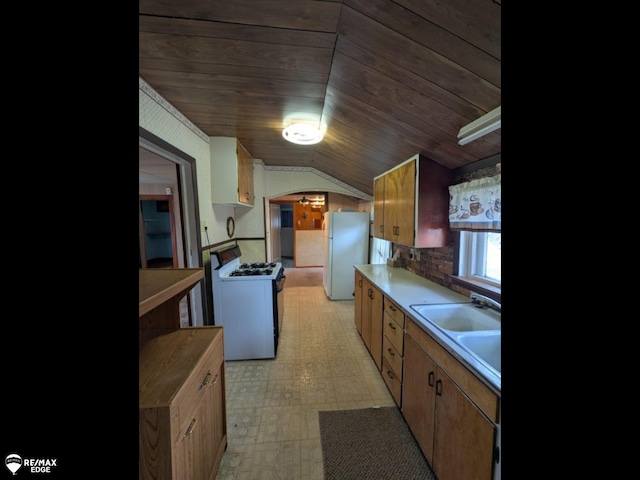 614 S Saginaw St, Lapeer, MI 48446 - kitchen featuring white appliances, wood ceiling, vaulted ceiling, and light floors