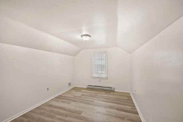 9233 Mckinney St, Detroit, MI 48224 - additional living space featuring baseboard heating, baseboards, vaulted ceiling, light wood-type flooring, and visible vents