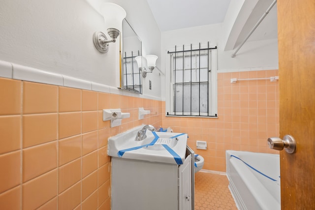 9233 Mckinney St, Detroit, MI 48224 - full bath with vanity, tile patterned floors, a wainscoted wall, a tub to relax in, and tile walls