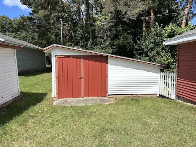 view of shed featuring fence