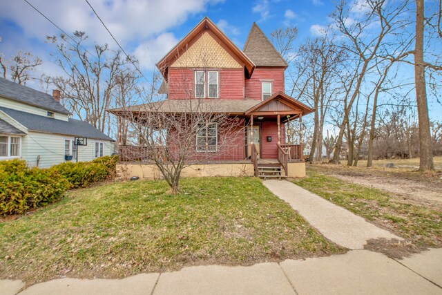 victorian home featuring covered porch and a front yard