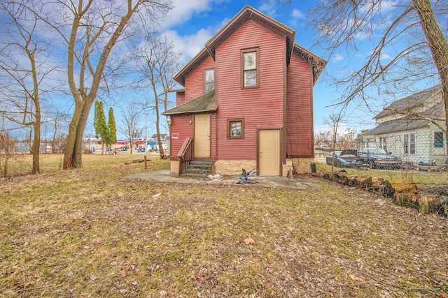 rear view of house with a yard