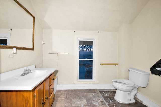 bathroom featuring vanity, a textured ceiling, and toilet
