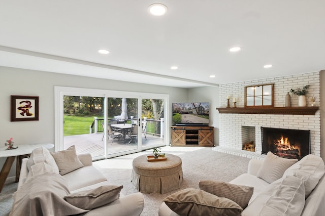 carpeted living room with recessed lighting and a brick fireplace