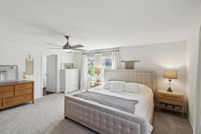 carpeted bedroom with a ceiling fan and baseboards