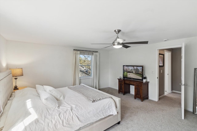 bedroom with baseboards, ceiling fan, and light colored carpet