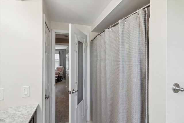 bathroom with curtained shower and vanity