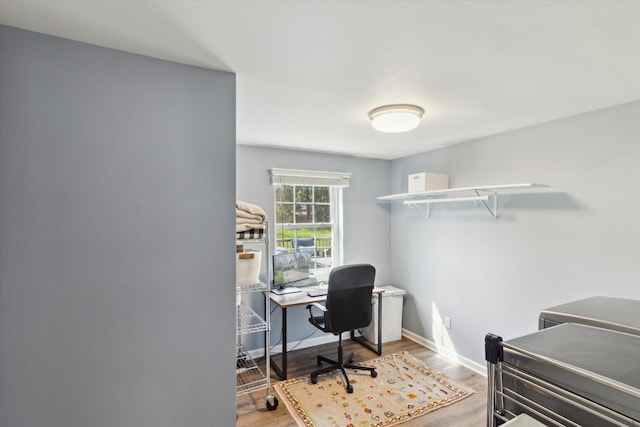 home office featuring baseboards and wood finished floors