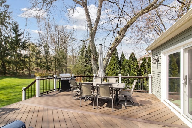 wooden deck with a lawn, area for grilling, and outdoor dining space