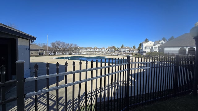view of yard featuring a residential view, a community pool, a patio area, and fence