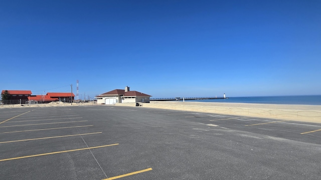 uncovered parking lot with a water view