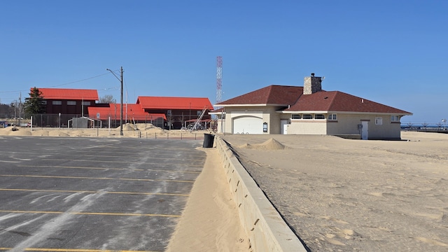 exterior space featuring fence and parking