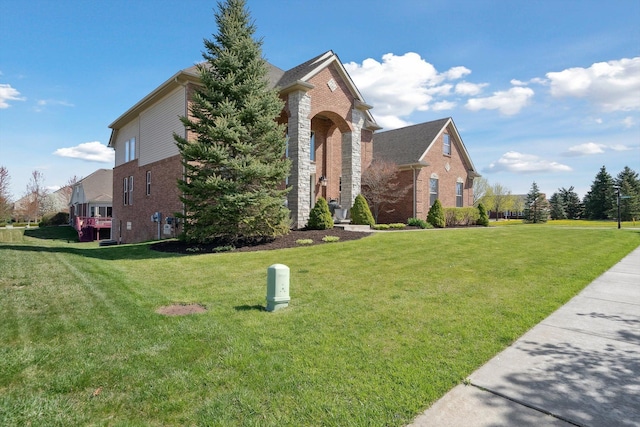 54210 Birchwood Dr, South Lyon, MI 48178 - view of front of house featuring brick siding and a front lawn