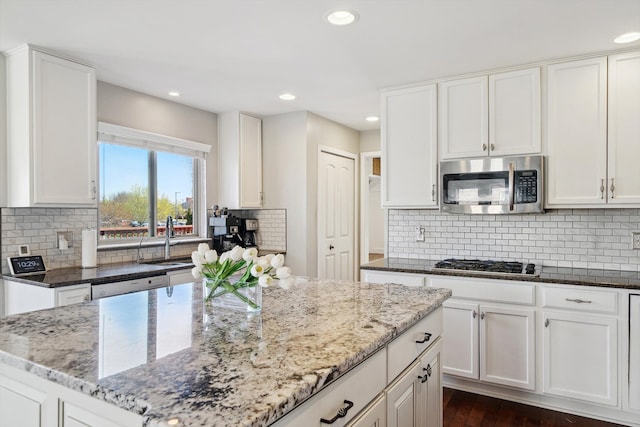 54210 Birchwood Dr, South Lyon, MI 48178 - kitchen with stainless steel appliances, light stone counters, and recessed lighting