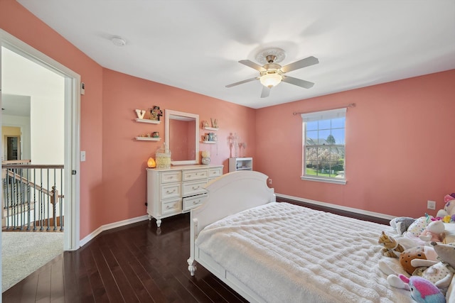 bedroom with baseboards, dark wood-type flooring, and ceiling fan