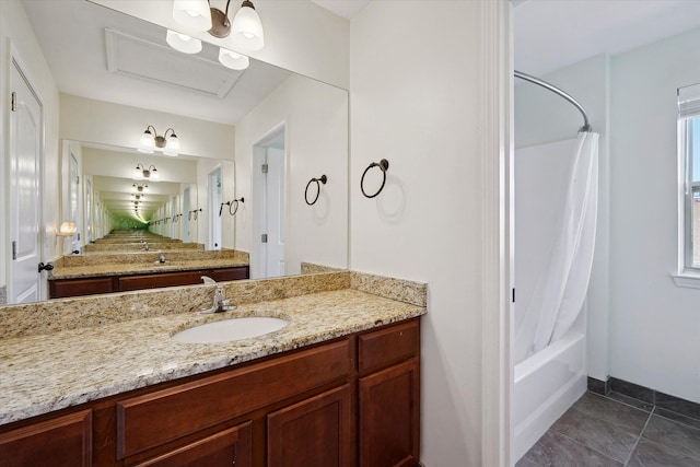 bathroom featuring vanity, baseboards, and shower / bath combo