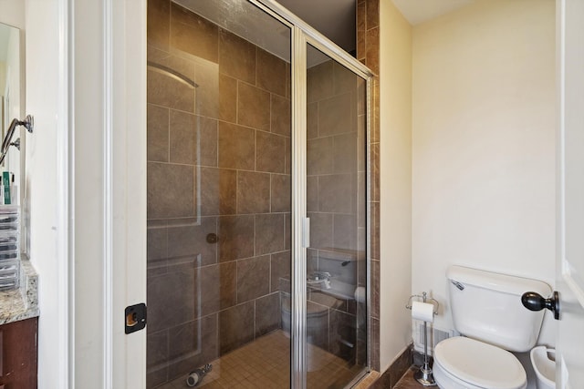 full bath with baseboards, a stall shower, and toilet