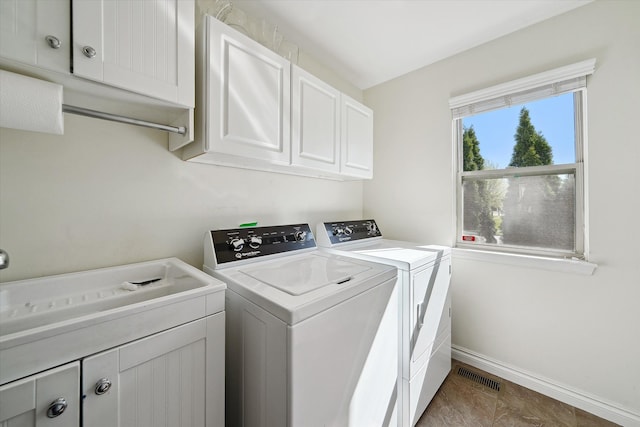 laundry area with cabinet space, independent washer and dryer, baseboards, and visible vents