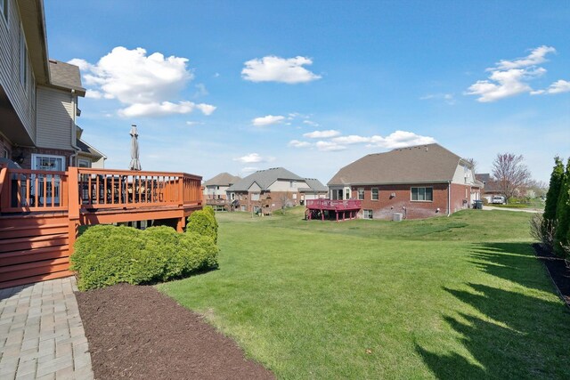 view of yard featuring a deck and a residential view