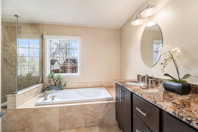 full bath with a tile shower, a garden tub, and vanity