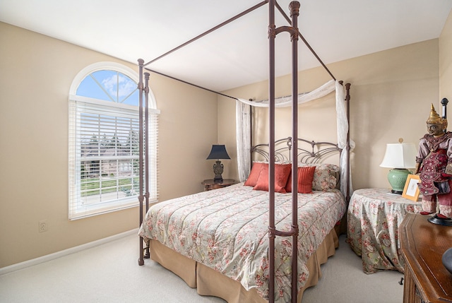 bedroom with carpet, multiple windows, and baseboards