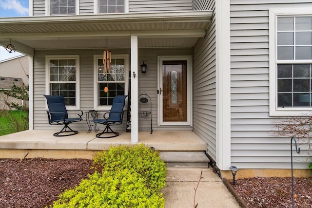 view of exterior entry with a porch