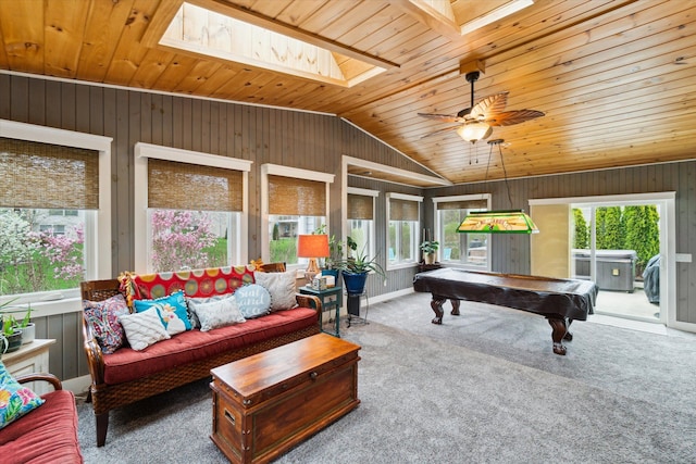 rec room with wooden walls, plenty of natural light, wood ceiling, and vaulted ceiling with skylight