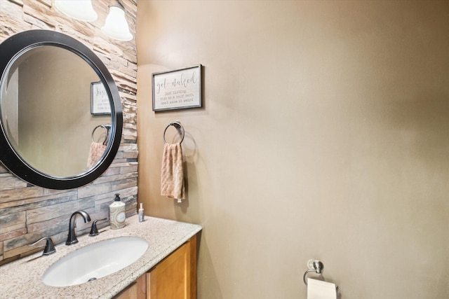 bathroom featuring vanity and decorative backsplash