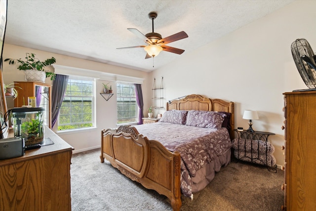 bedroom featuring light colored carpet, a textured ceiling, baseboards, and ceiling fan