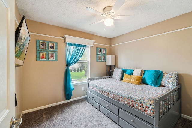 bedroom with carpet floors, baseboards, a textured ceiling, and ceiling fan