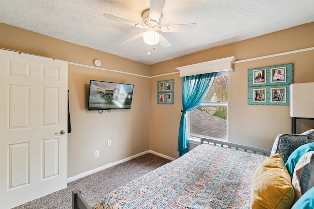 carpeted bedroom with a textured ceiling, baseboards, a ceiling fan, and access to outside
