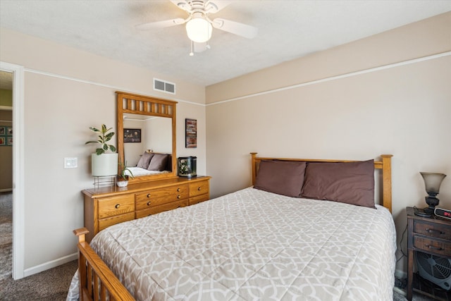 bedroom with visible vents, baseboards, carpet floors, and ceiling fan