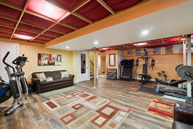 workout room with recessed lighting, baseboards, and wood finished floors