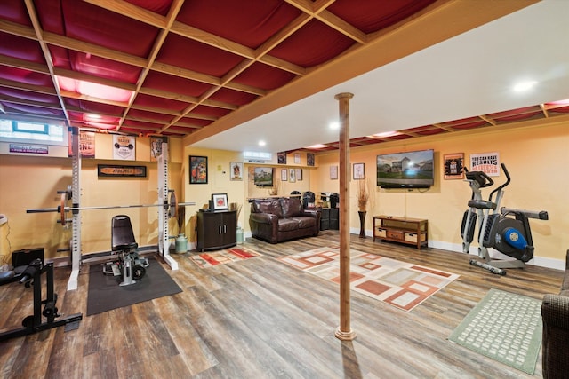 workout room with baseboards and wood finished floors